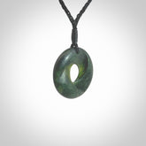 This small sized piece is a hand carved möbius ribbon pendant. Kyohei Noguchi has carved this from New Zealand Nephrite Jade. It has very subtle colour variations in the stone and is a delightful, small and artistic piece of jewellery. Delivered with an adjustable black cord.